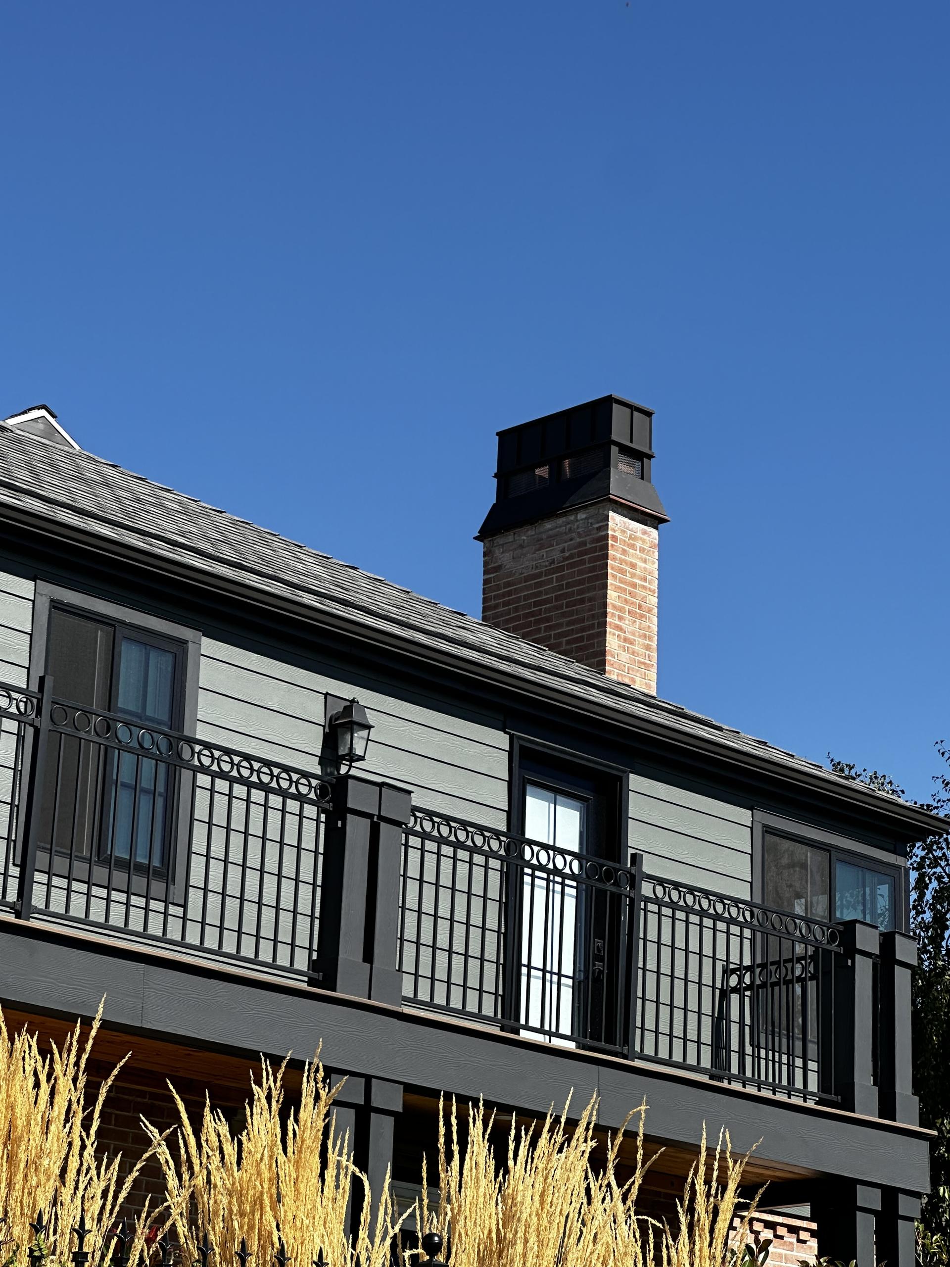 House with custom metal chimney cap.